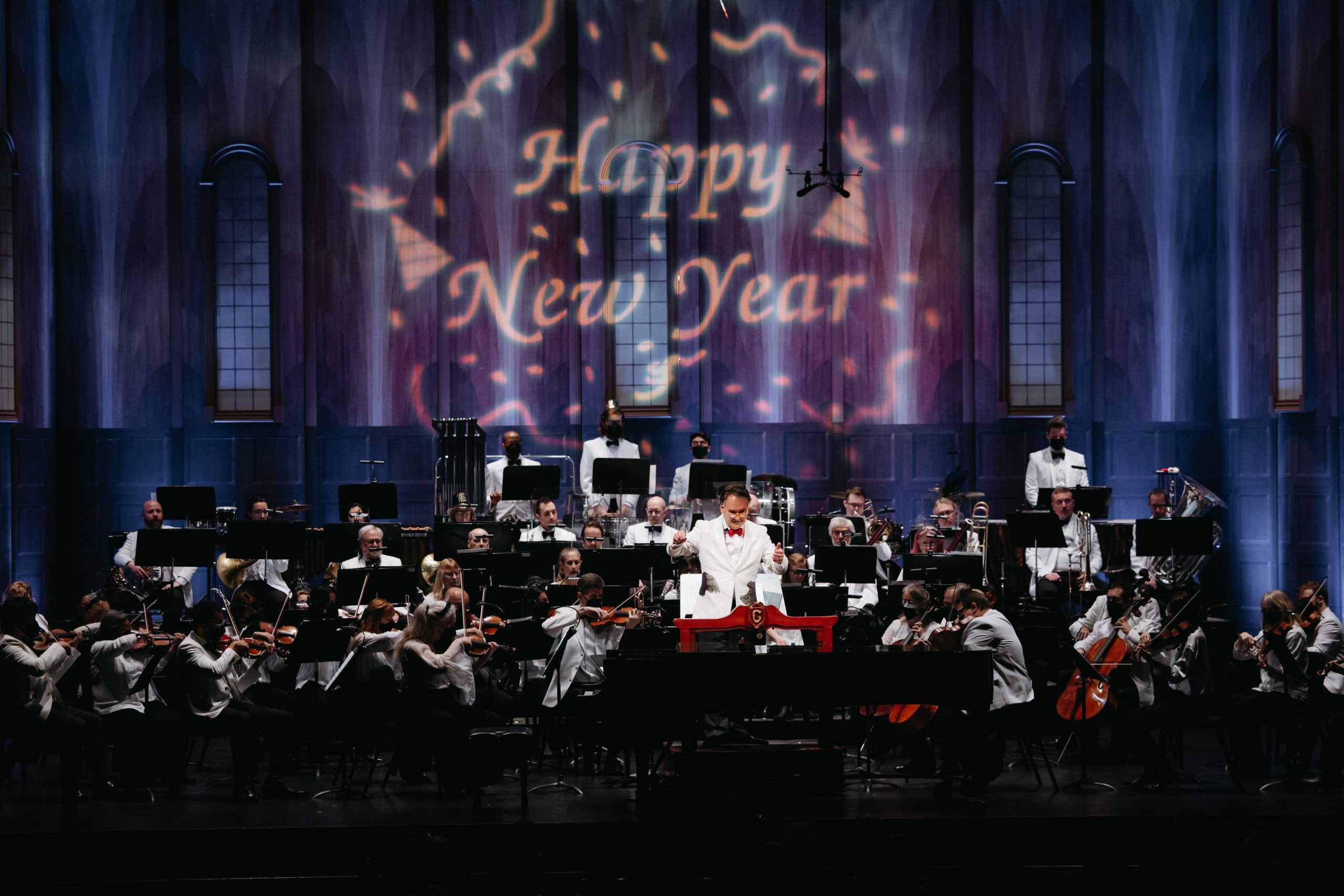 The Santa Barbara Symphony paying in front of a backdrop with