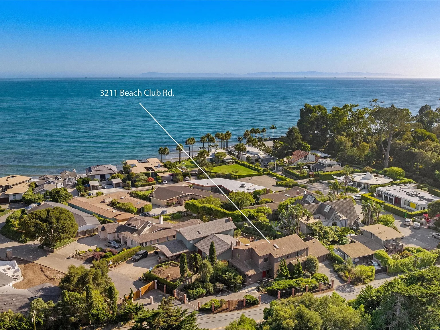 A birds eye view of Carpinteria looking out to the ocean with an arrow marking a home for sale.