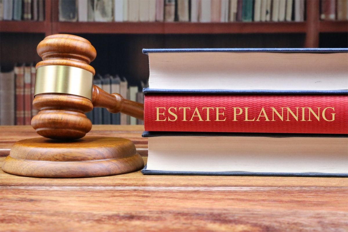 A gavel and 3 books on a desk. One books title is "Estate Planning."