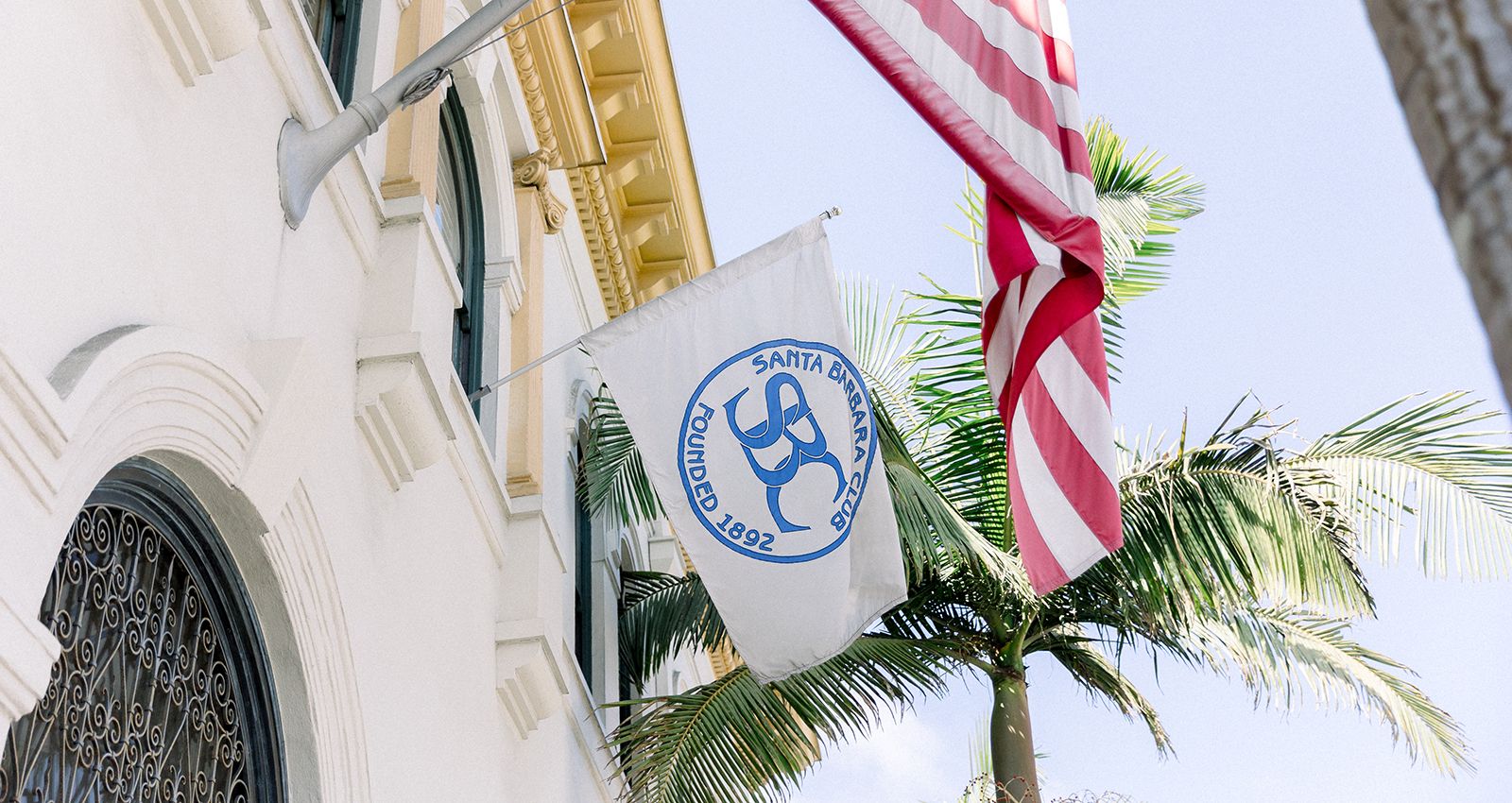 American and SBC flags hang above the entrance of the Santa Barbara Club