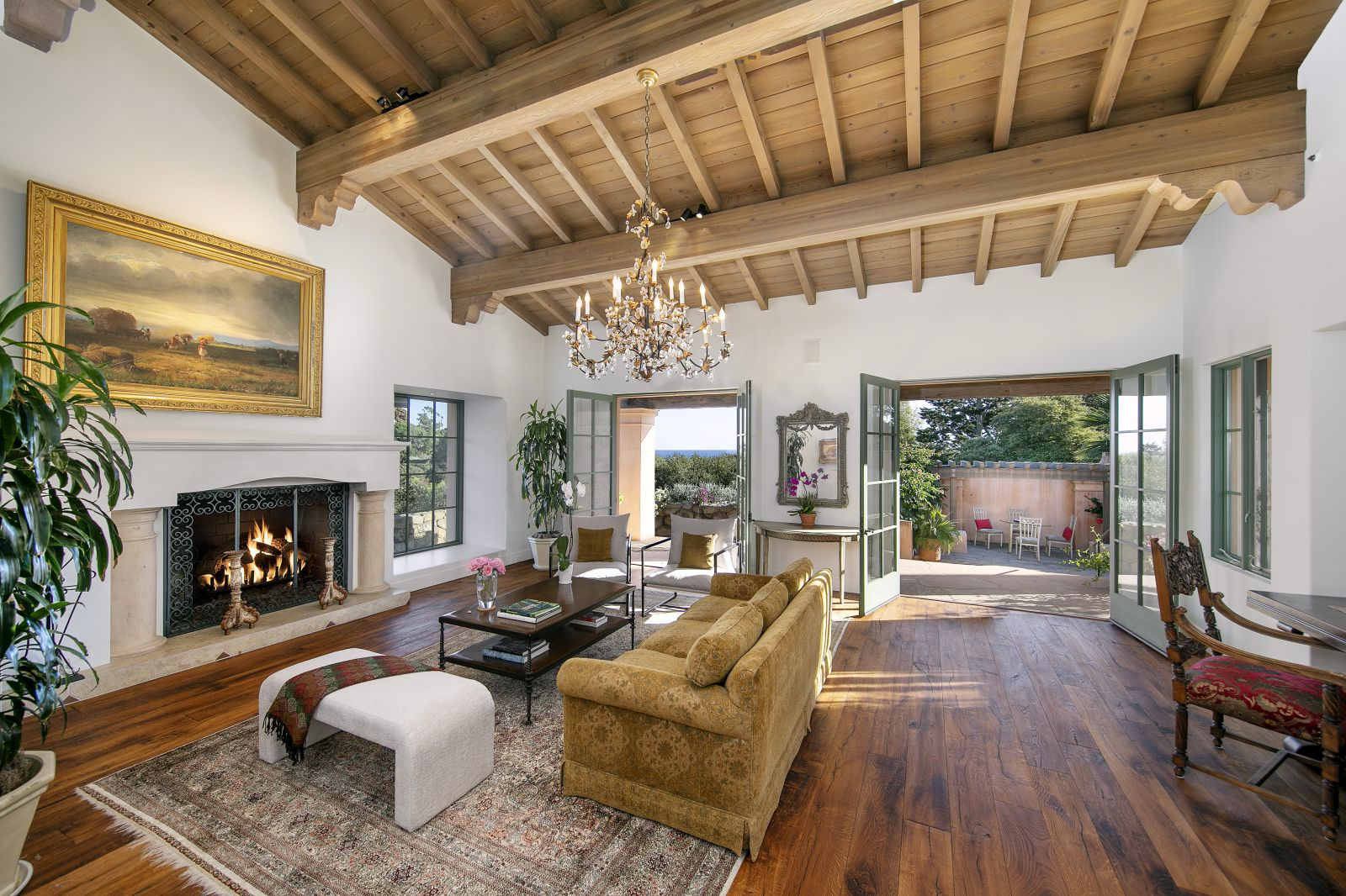 A luxury living room wiht French Doors open to an outside patio
