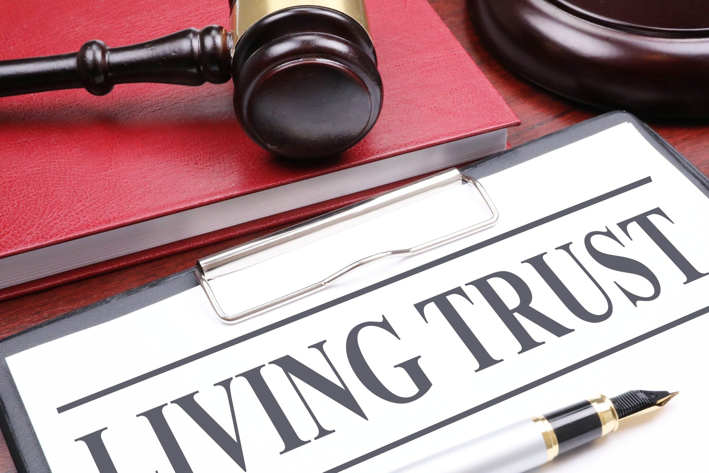 A Living Trust document on a desk with pen and gavel