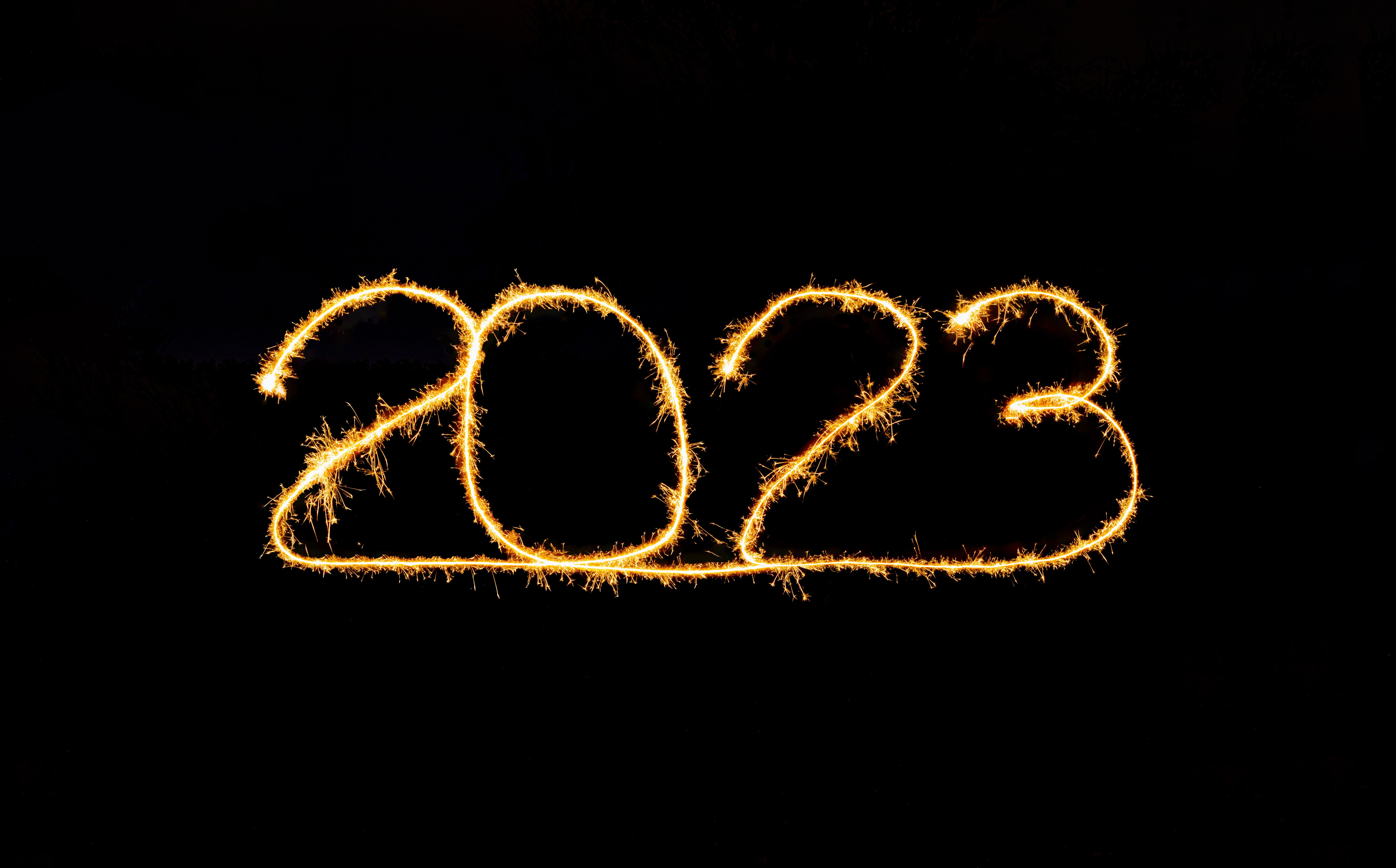 the number 2023 in lights on a black canvas