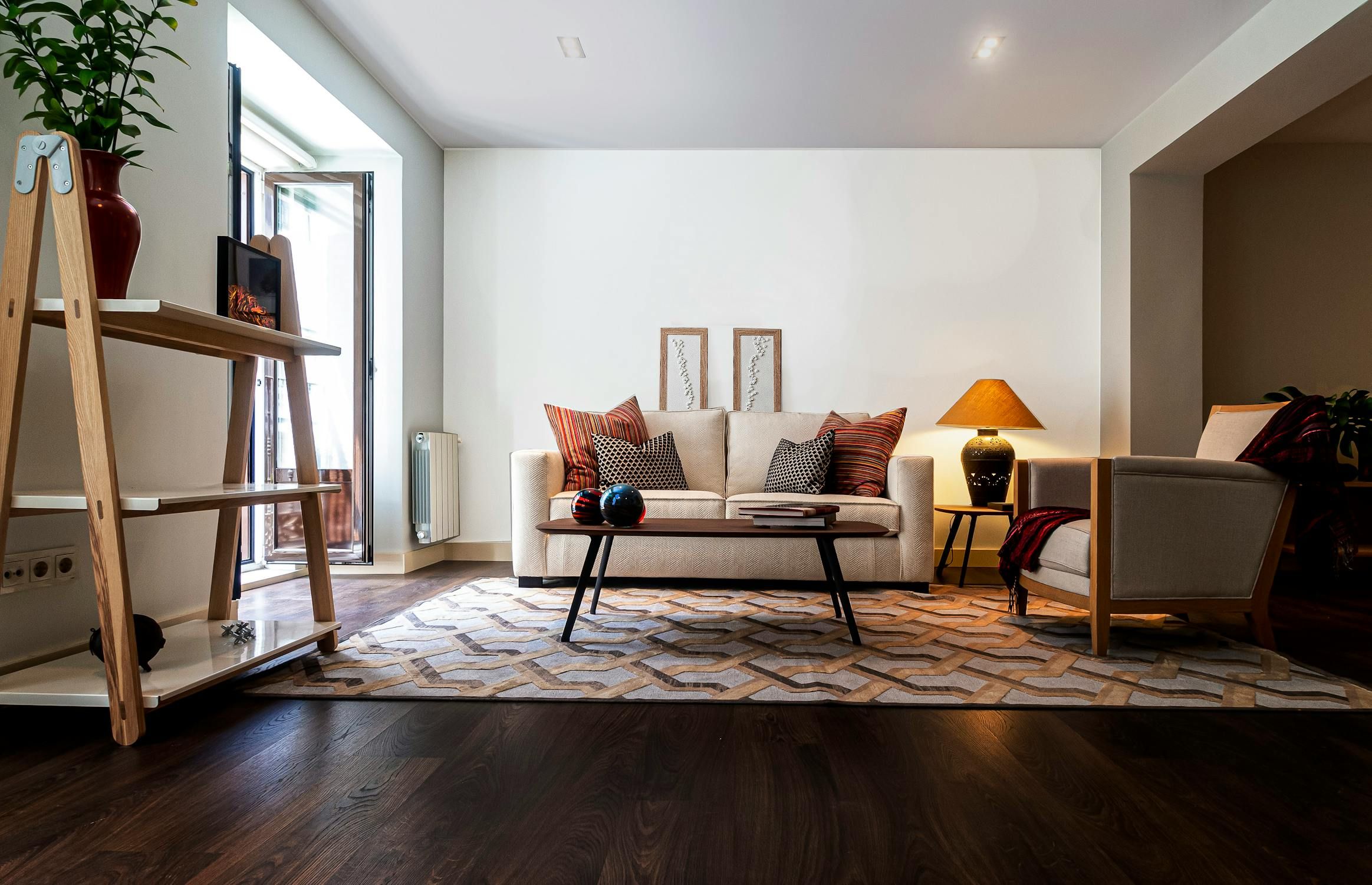 A mid century furnished living room with couch, chair, coffee table and more.