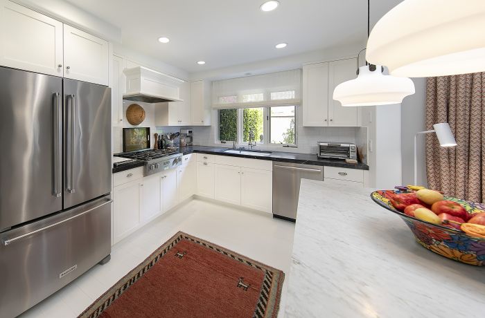 Kitchen of a Montecito townhouse, with stainless steel appliances and stone countertops