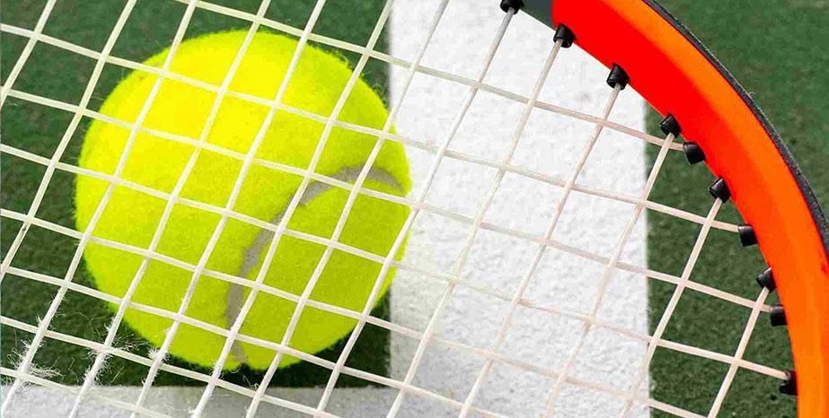 A close up shot of a tennis ball and racquet.