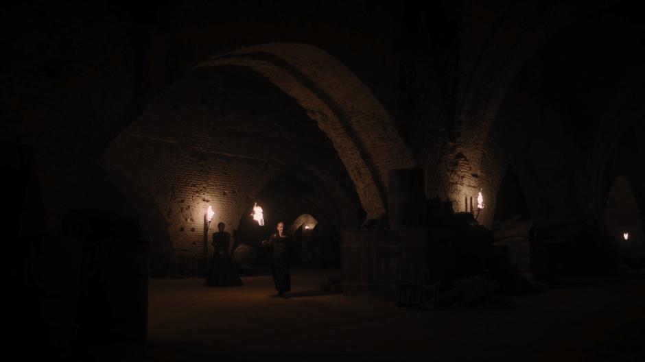 Qyburn leads Cersei over to one of the giant dragon skulls.