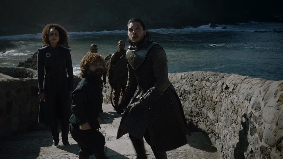 Tyrion helps Jon stand up after one of the dragons flew overhead.