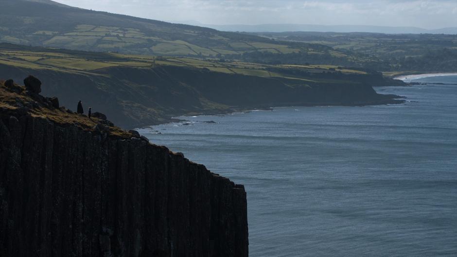 Tyrion stands next to Jon as he broods on the cliff.