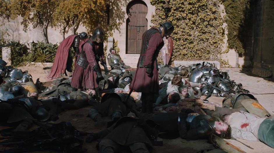 A few Lannister soldiers search through the bodies of the Tyrell defenders.