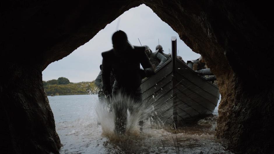 Grey Worm leads his small group through the water into the cave.