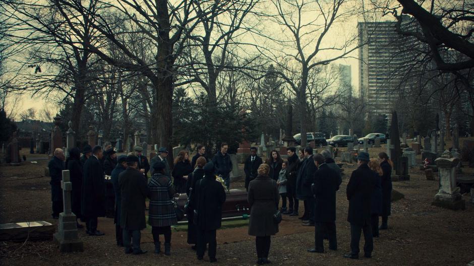 Siobhan's friends and family surround her grave during the funeral.