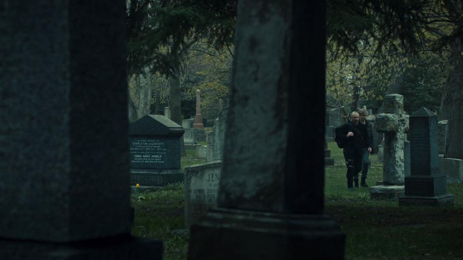 Valentine and Jonathan walk through the graveyard.