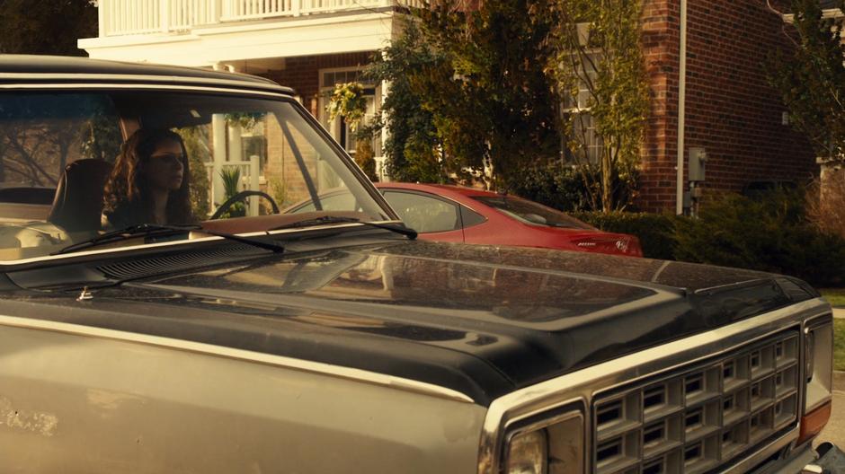 Sarah psychs herself up to go to the party while sitting in her truck out front.