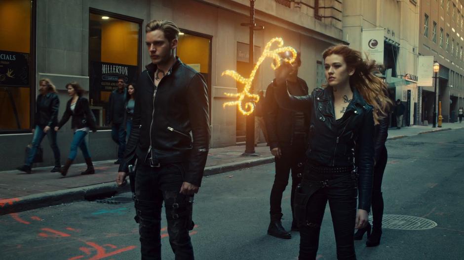 Clary writes her new portal symbol in the air while Jace stands ready to leave for Idris.