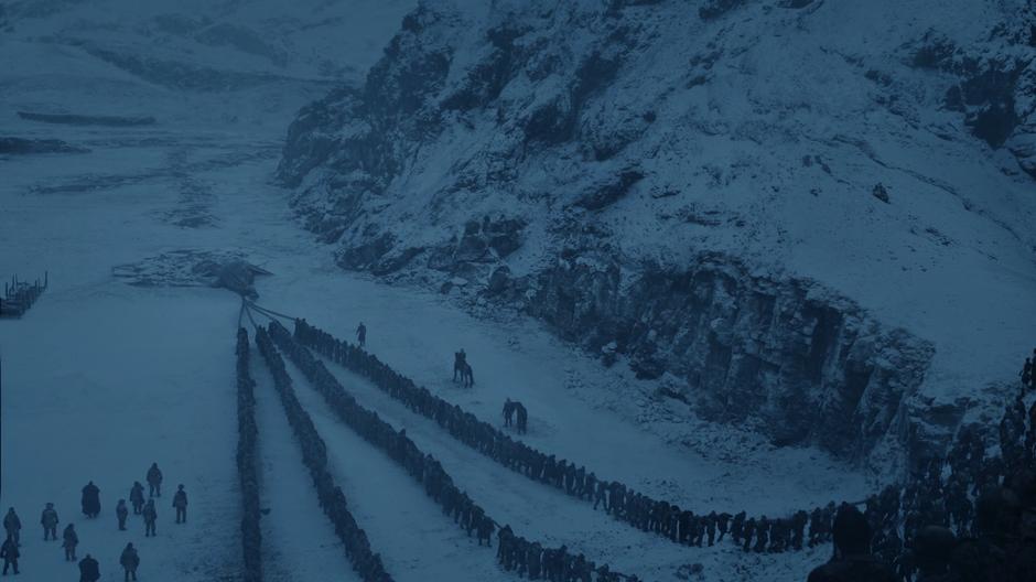 The dead drag the dead dragon from the water while the Night King supervises.