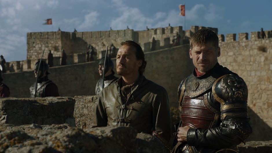 Bronn and Jaime look down on the army from the battlements.
