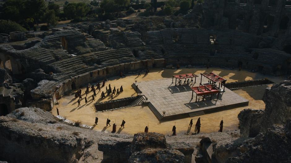 The group head up onto the platform while the Lannister soldiers circle around the perimeter.