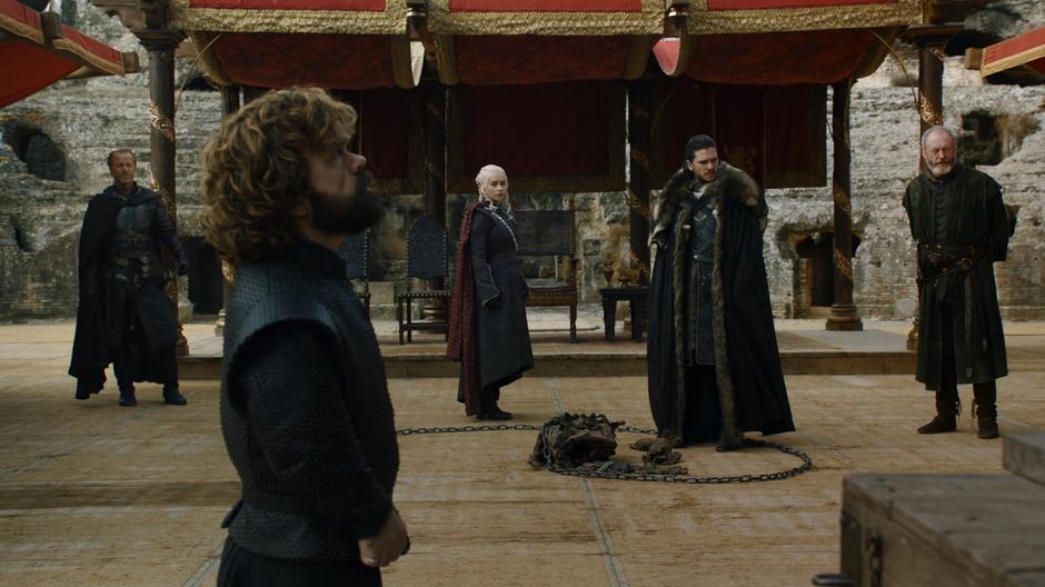 Jorah, Tyrion, Daenerys, Jon, and Davos stand around frustrated after Cersei storms out.