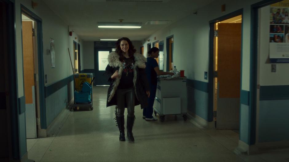 Wynonna struts down the hall of the hospital with the cure in her hand and a giant grin on her face.