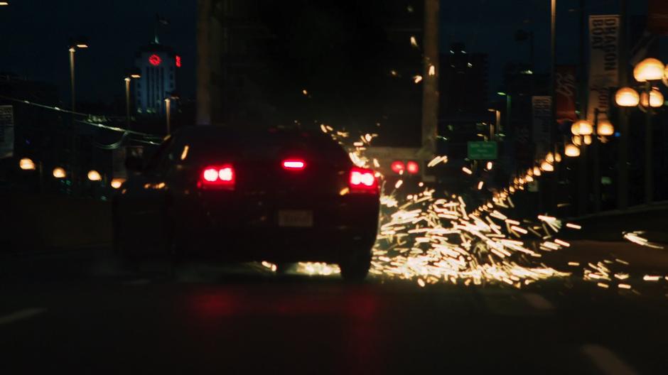 Maggie and Alex's car shoots off sparks as it rams against the back of the truck.