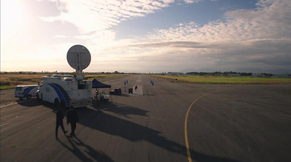 Wally and Joe walk up to the testing area that Cisco has set up on the runway.