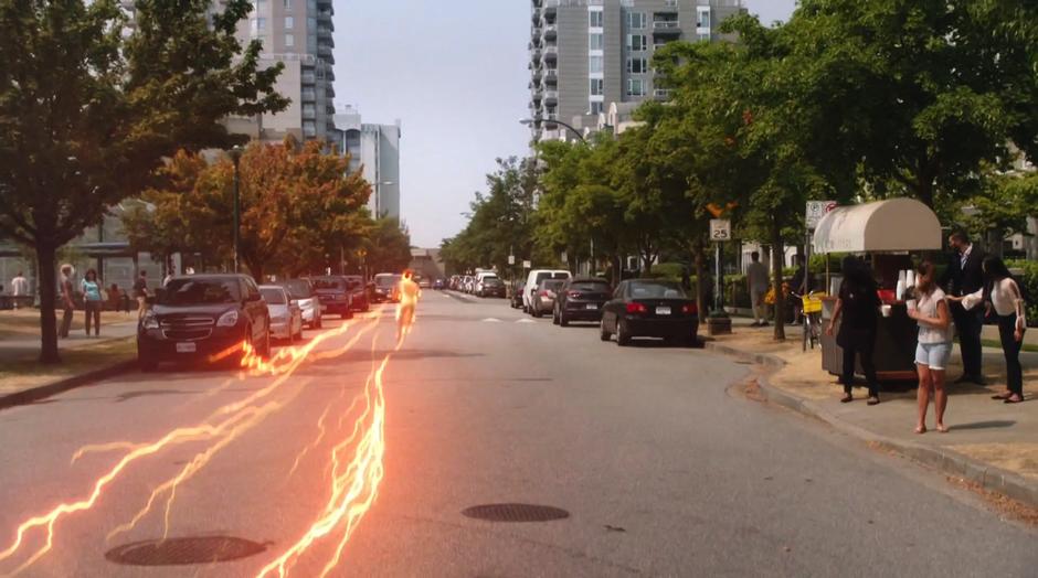 Barry runs down the street away from the portal.