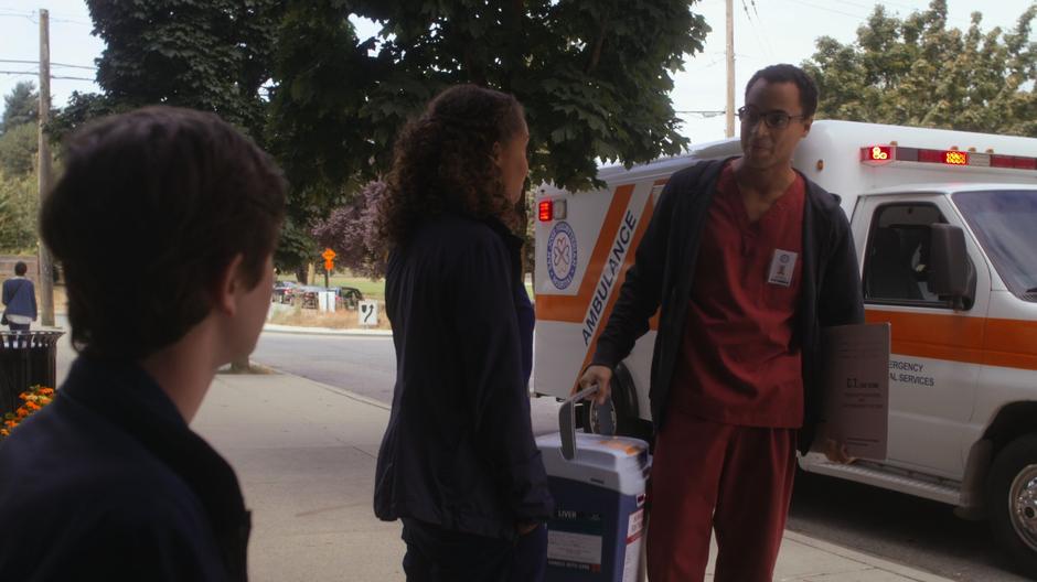 A doctor from another hospital takes the liver from Claire while Shaun sits on the bench.