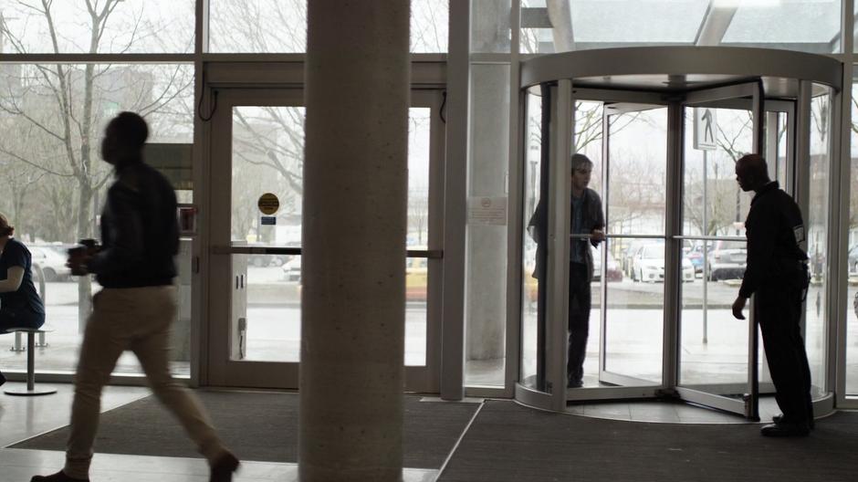 Shaun tries to enter the hospital through a revolving door but a security guard stops him.