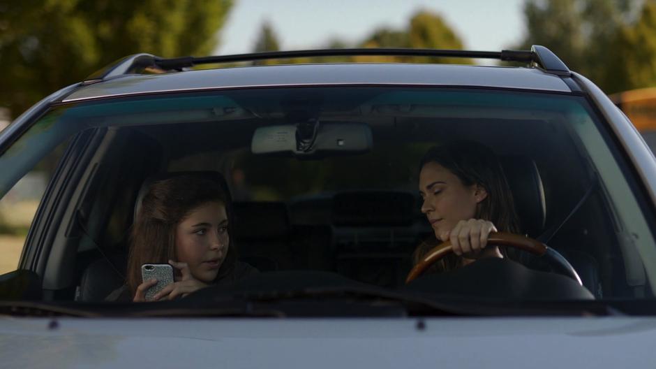 Sam talks to Ruby who is checking her phone in their car.