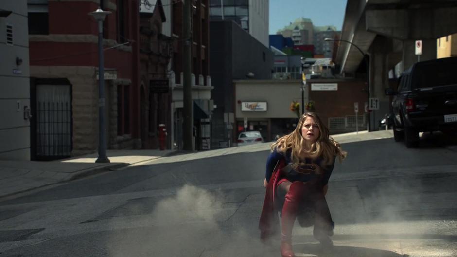 Kara lands in the street near Psi.