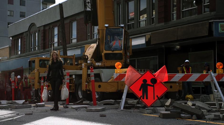 Psi sees Kara while standing in the middle of the wreckage in front of the crane.