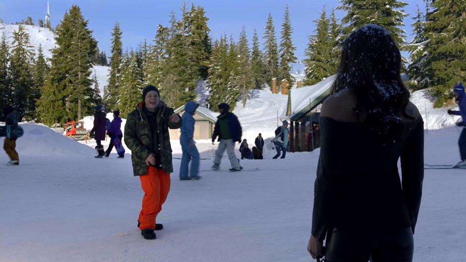 Some asshole points and laughs at Maze after she is dumped with snow.