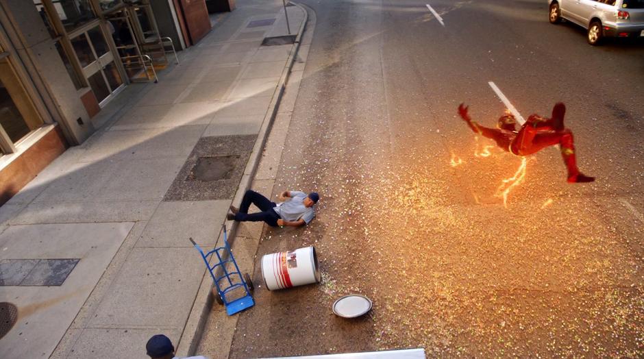 Barry slips on the marbles while running after Rebecca Sharpe as the Flash.