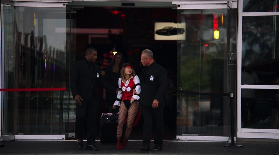 Rebecca Sharpe is thrown out of the casino by two guards.