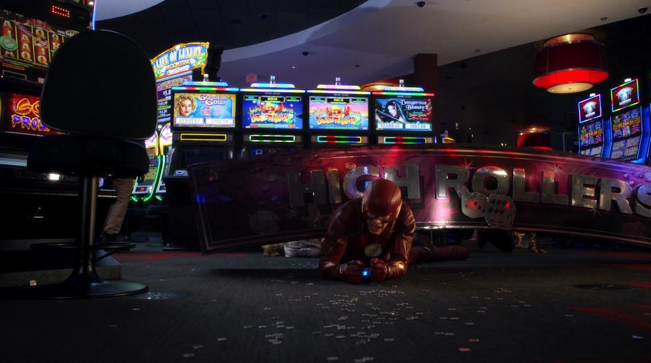 Barry struggles to get out from under the sign after being trapped and handcuffed.