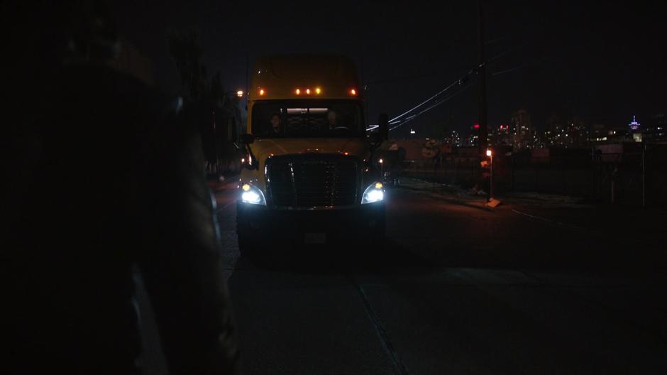Diggle stands in the road and stops the transport truck.