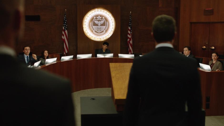 Oliver approaches the lecture to speak with the city council.