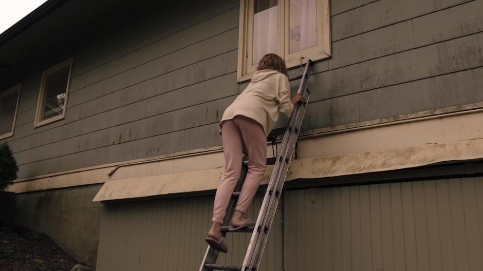 Suzie climbs the ladder up to her bedroom window.