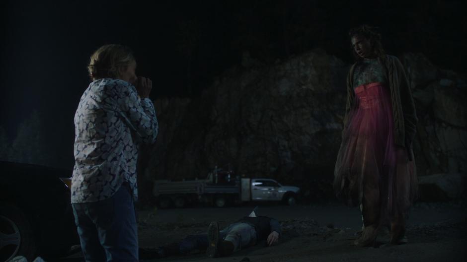 Suzie kneels on the ground in terror as Bart says she isn't going to kill her.