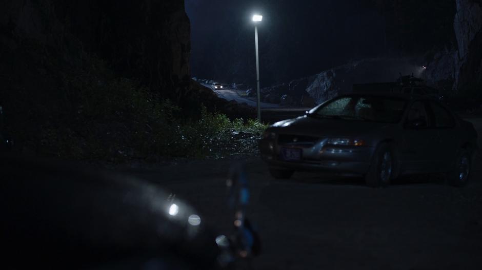 Suzie drives back into the quarry at night.