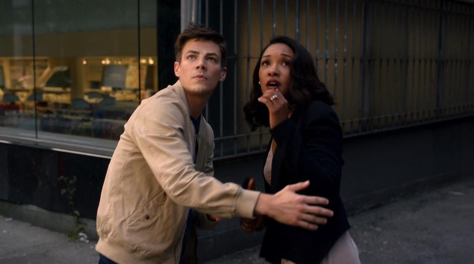 Barry and Iris look up after the building explodes.