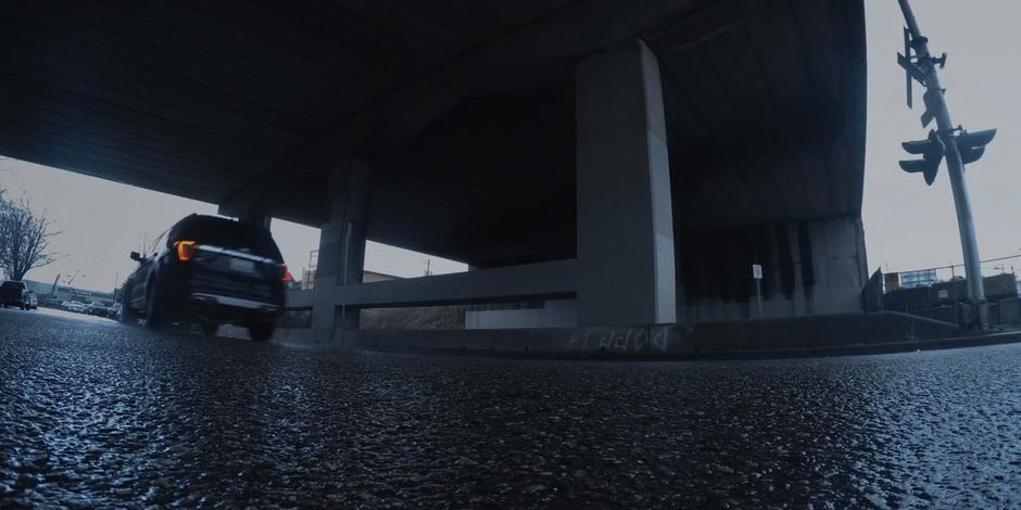 Grant's SUV drives through the underpass.