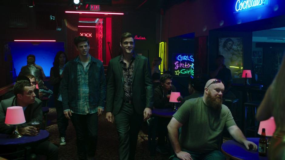 Dibny leads Barry, Cisco, and the others into the strip club.