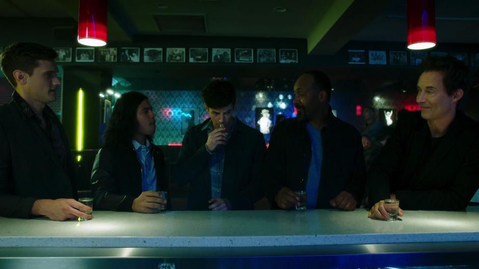 Barry takes a sniff of the special drink Cisco whipped up for him while Dibny, Cisco, Joe, and Wells wait to drink.