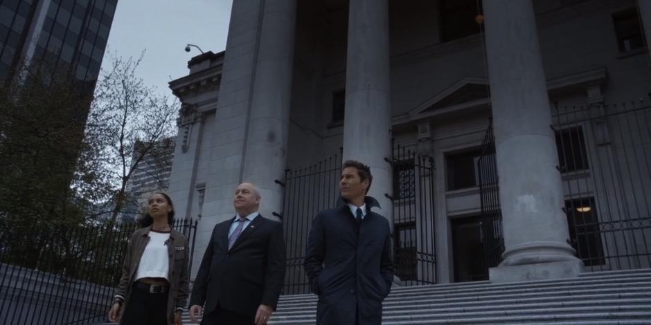 Carly, Ted Bishop, and Grant look around the steps where the speech will take place in preparation for the assassination.