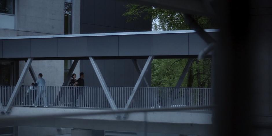 Kat and Grant walk across the skybridge after their appointment.