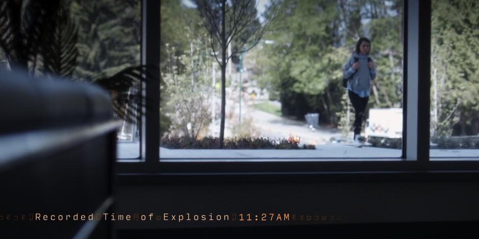 Abby walks up to the front door of the building while a timer shows when the explosion will occur.