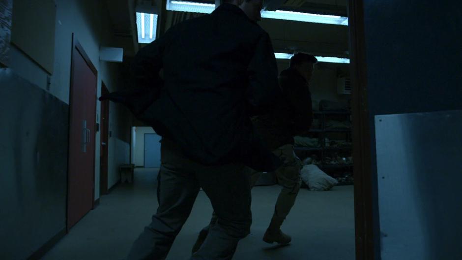 Two Jackals run through a door away from Slade.