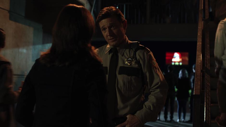 Sheriff Collins listens to Alex's new information.